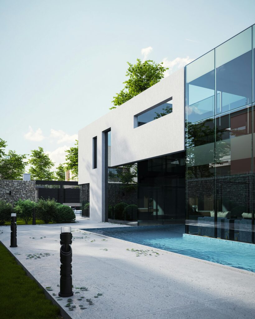 Contemporary luxury home exterior with glass facade and swimming pool. Lush garden setting.